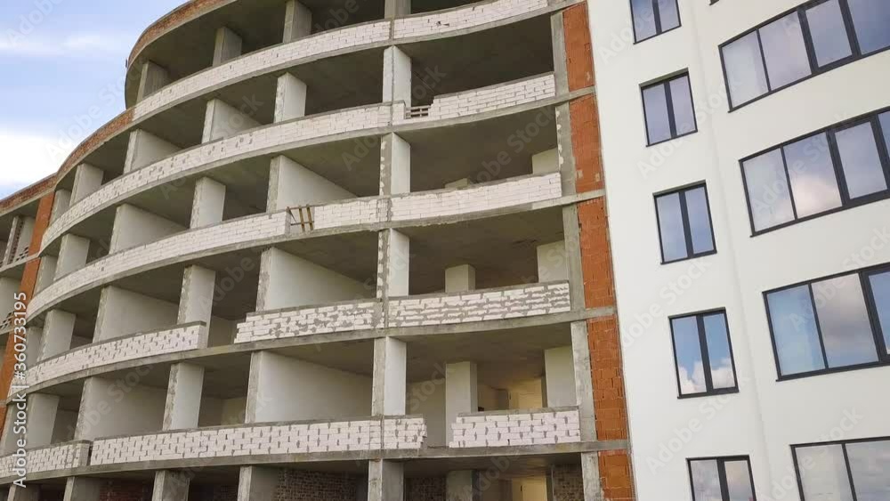 Many windows on new apartment building facade under construction. Many windows on new apartment building facade under construction.
