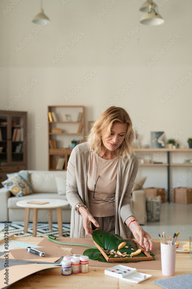 Creative designer of interior making composition out of green leaves and plants Creative designer of interior making composition out of green leaves and plants