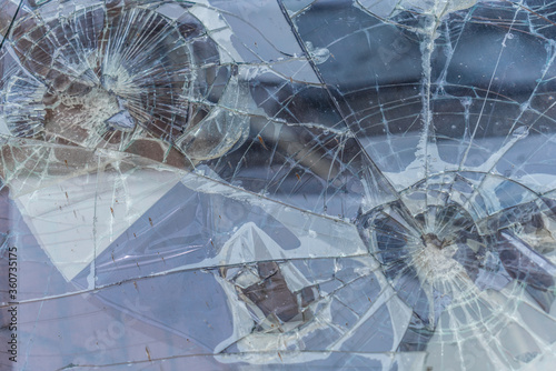 Broken glass, traces of shots in bulletproof glass. Background texture photo