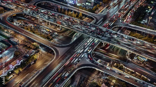 TL/PU Asia, China, Beijing, Aerial view Pan Up Time lapse of busy road intersection in Beijing's financial district, with  traffic and commuters during evening rush hour
