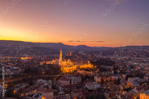 Aerial drone shot of lighted Matthias Churh Fisherman's Bastion on Buda Hill in Budapest sunset time