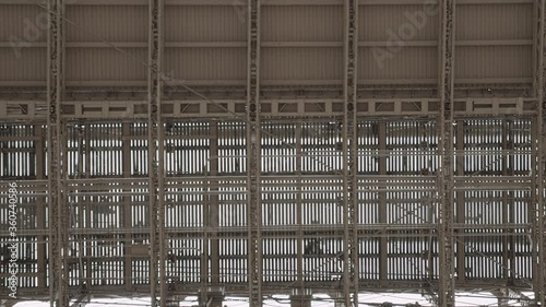 Abstract geometrical mesh, walking people silhouettes, Brooklyn Bridge New York City
