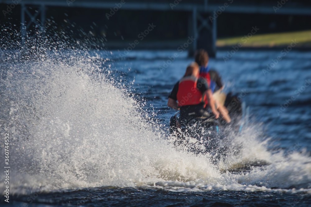 Naklejka premium View of jet ski in motion, group of jet skiers with a big water splash