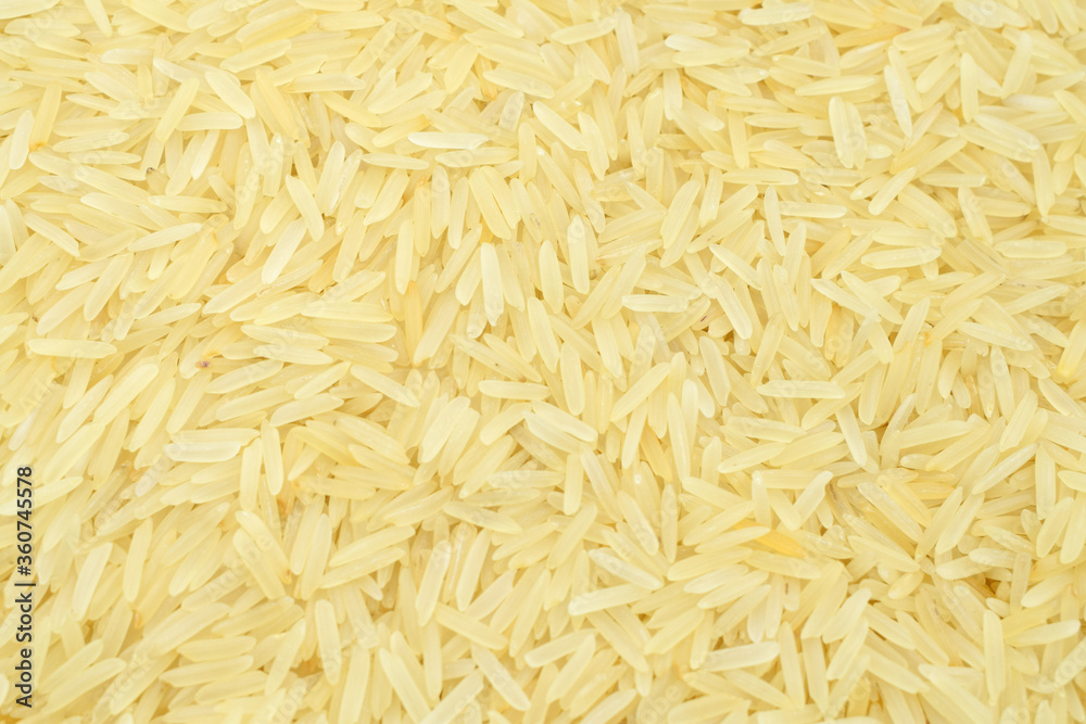 Brown long rice background, uncooked raw cereals, macro closeup Brown long rice background, uncooked raw cereals, macro closeup