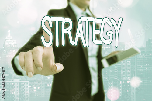 Writing note showing Strategy. Business concept for action plan or strategy designed to achieve an overall goal Touch screen digital marking important details in business photo