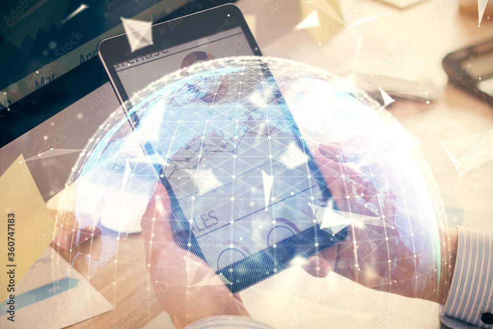 Double exposure of man's hands holding and using a phone and international business theme drawing. Double exposure of man's hands holding and using a phone and international business theme drawing.