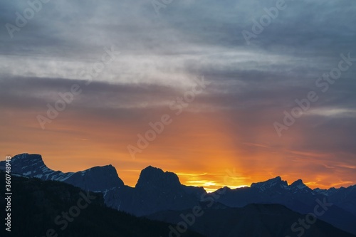Dramatic Orange Sunset Colored Sky Behind Rugged Mountain Peaks Evening Landscape, Banff National Park Canadian Rockies
