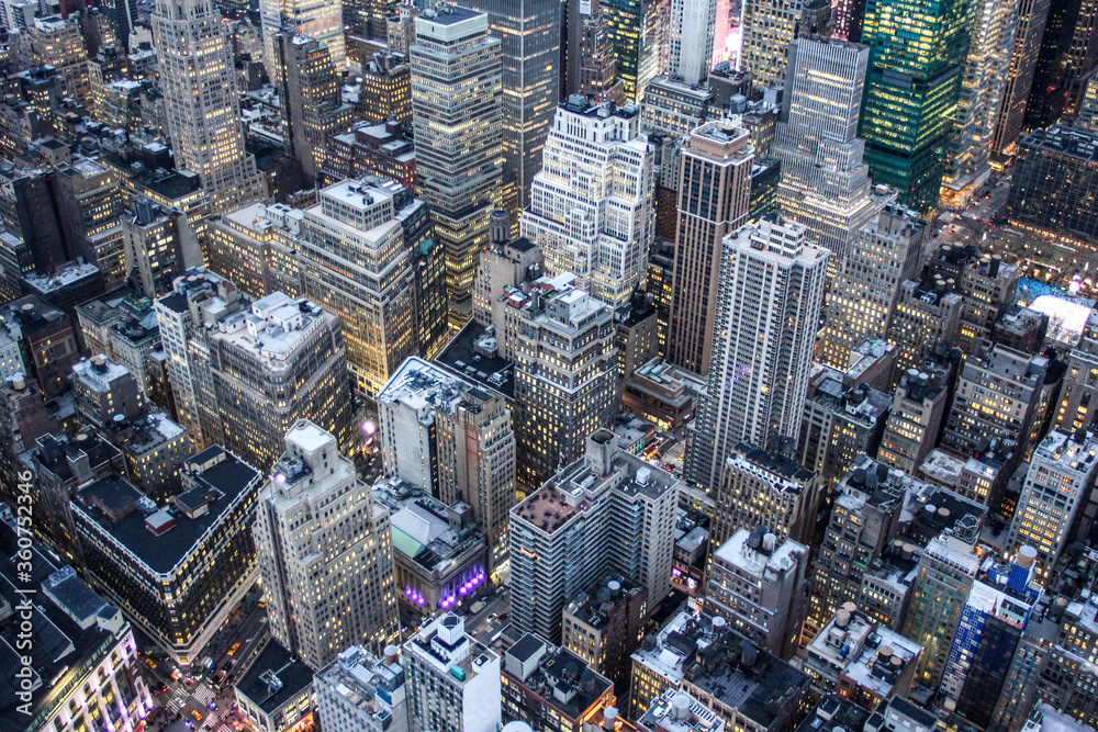 Fototapeta premium Illuminated New York skyline with skyscrapers seen from an aerial view