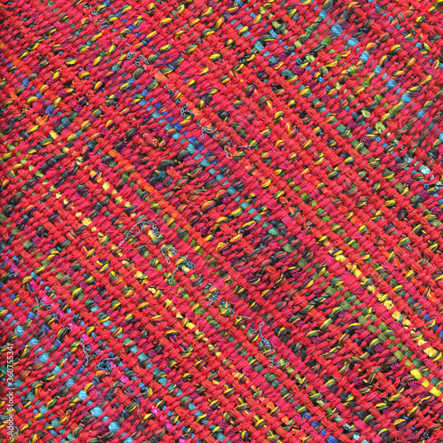 Closeup of colorful handwoven fabric with red weft