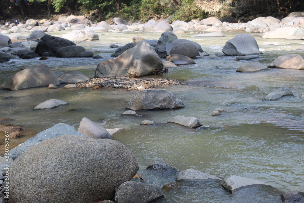 Fototapeta premium Rocks in the river in West Java. Large stones in the water.