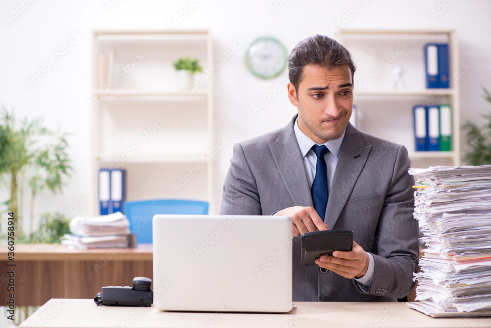 Young male businessman unhappy with excessive work Young male businessman unhappy with excessive work