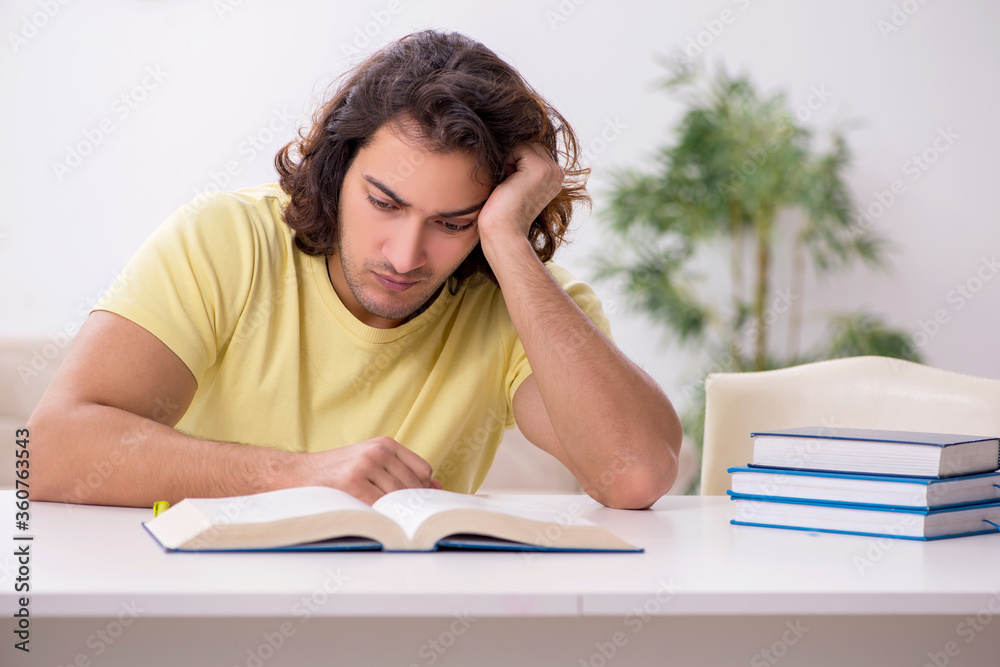 Young male student preparing for exams at home Young male student preparing for exams at home