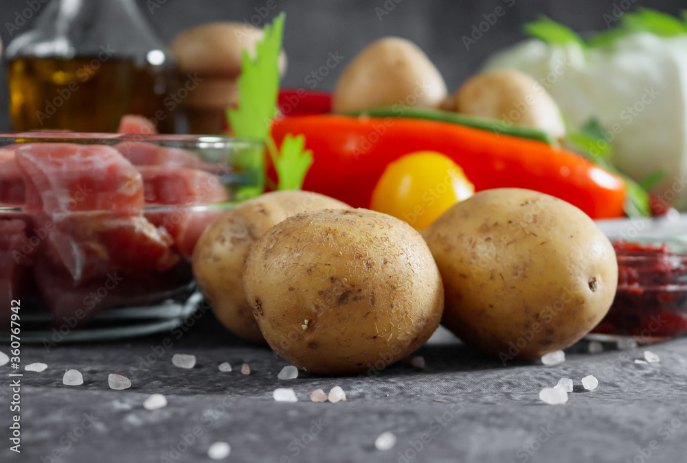 three potatoes with meat and vegetables on a stone background, closeup side view.
three potatoes with meat and vegetables on a stone background, closeup side view.