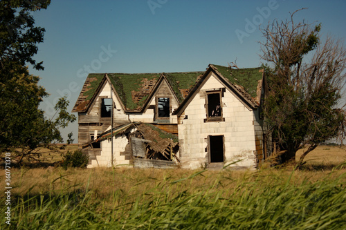 Dilapidated Abandoned Farm House in an Open Field in USA