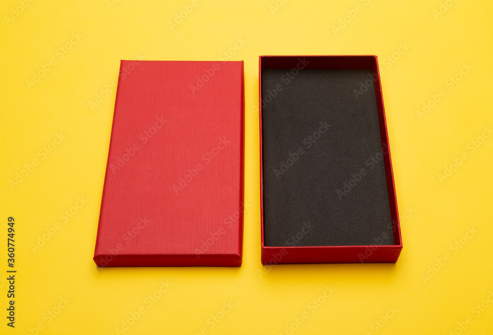Fototapeta premium Red box product packaging isolated on yellow background.