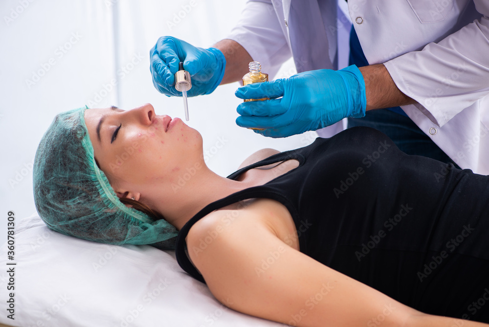 Young woman visiting male doctor dermatologist Young woman visiting male doctor dermatologist