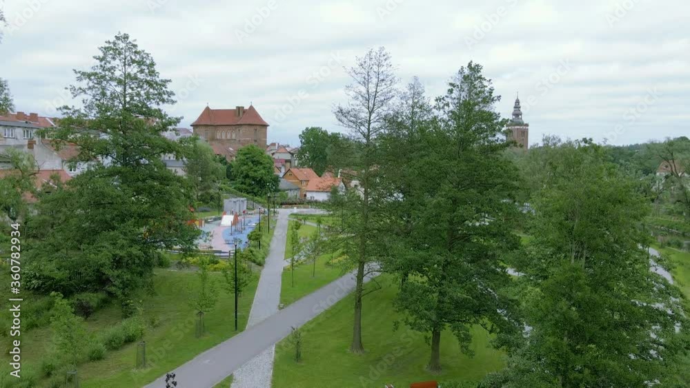 Descending aerial shot of blooming park with green trees and footpath in Poland Descending aerial shot of blooming park with green trees and footpath in Poland