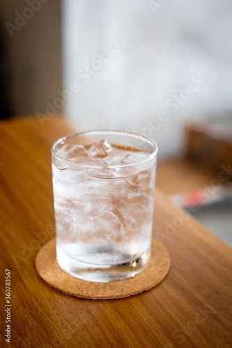 A glass of cold drinking water on wooden table