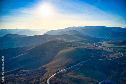 The road between the hills. Blue sky. Mountain panorama.