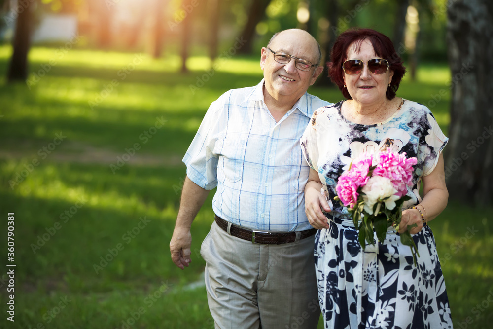 Happy elderly couple. Handsome man and woman senior citizens. Husband and wife of old age for a walk.