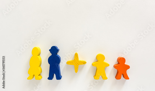 Colorful wooden figurines of the family. Parents and children on a light background. Family concept. Place for text.