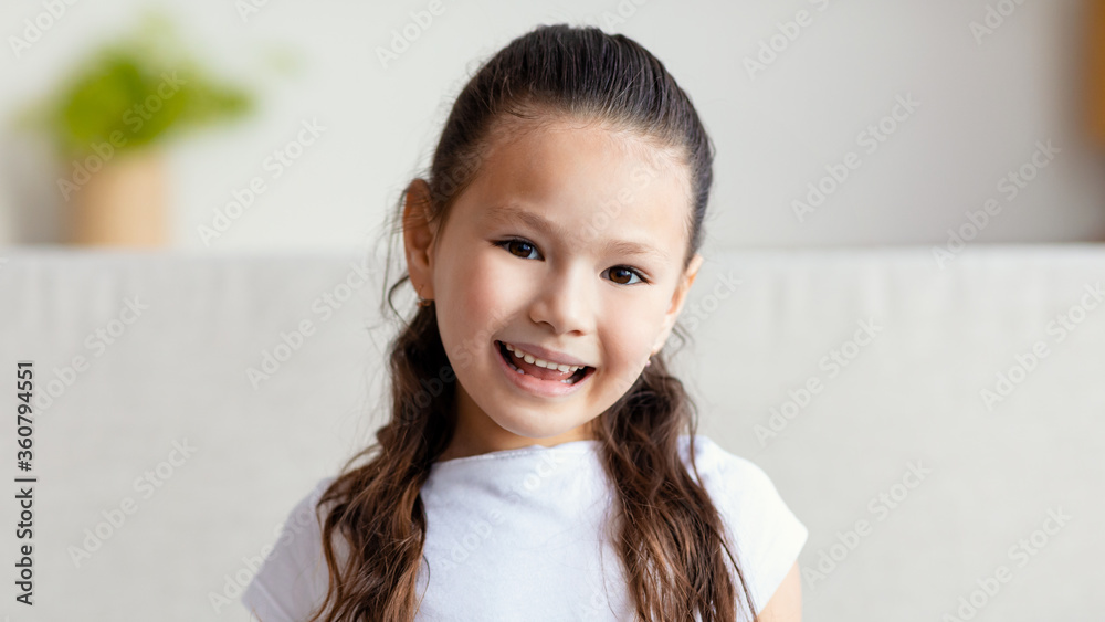 Asian Kid Girl Smiling Posing Sitting On Couch At Home Asian Kid Girl Smiling Posing Sitting On Couch At Home