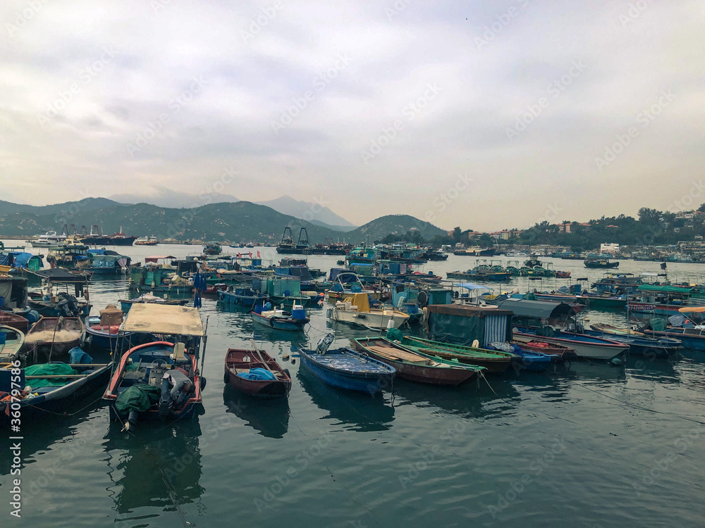 Boats stopped by the pier in the evening at Cheung Chau Island, Hong Kong.
