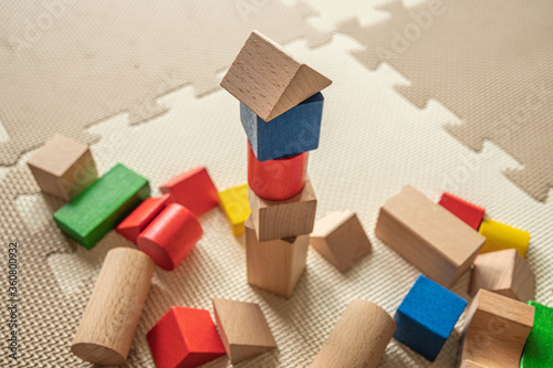 wooden building blocks on interlocking floor mat