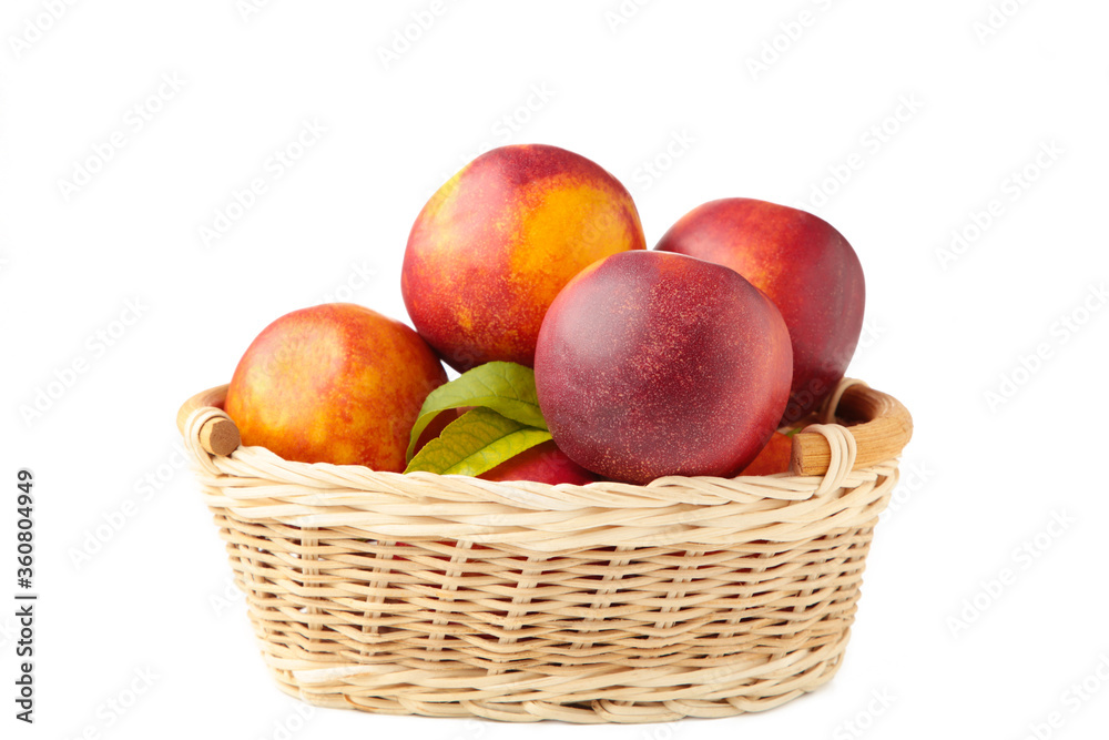 Nectarines in a basket isolated on white background Nectarines in a basket isolated on white background