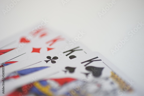 Side view of kings cards on a white table.
