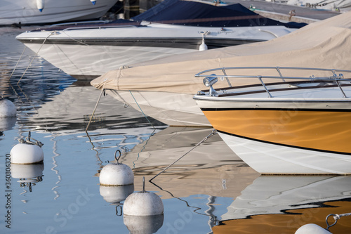 bow of yachts and reflections in a marina, Geneva