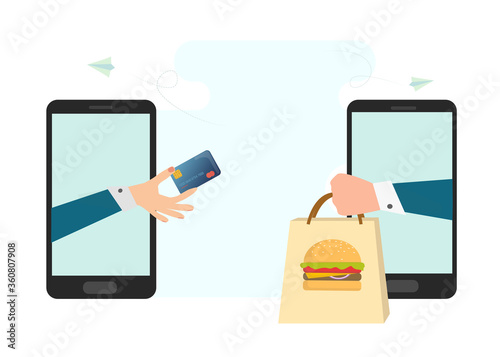 Hands of businessman and delivery man outstretching credit card, food