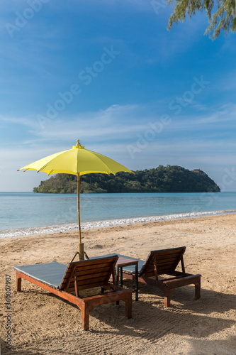 Fototapeta Naklejka Na Ścianę i Meble -  yellow beach umbrella and sunbed, Koh Mak beach, Koh Mak Island , Thailand.