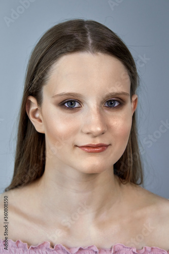 Cute young brunette girl with professional makeup.