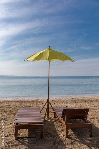 Fototapeta Naklejka Na Ścianę i Meble -  yellow beach umbrella and sunbed, Koh Mak beach, Koh Mak Island , Thailand.