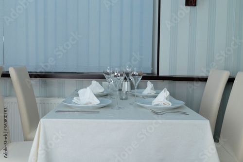 Table setting in a restaurant or a cafe. © indigolotos