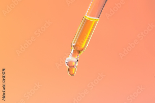 Liquid drop on pipette, image with color filter.