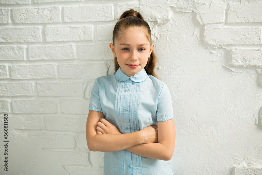 beautiful young teen girl on a background of a white wall beautiful young teen girl on a background of a white wall