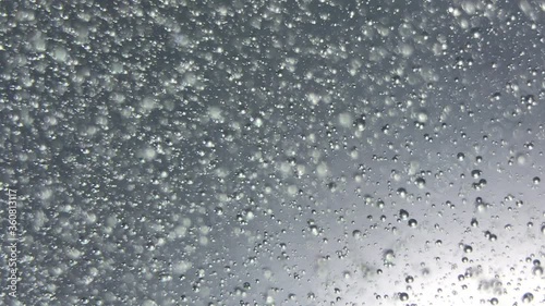 air bubbles float in liquid with colour light.