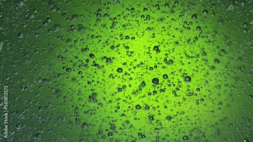 air bubbles float in liquid with colour light.