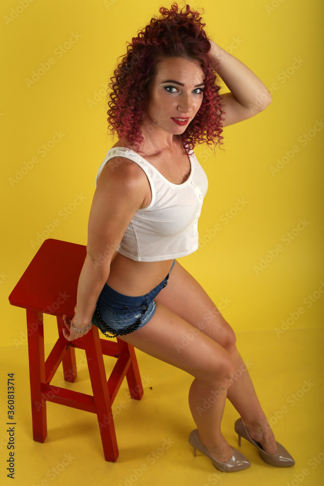 portrait of curly girl on a yellow background