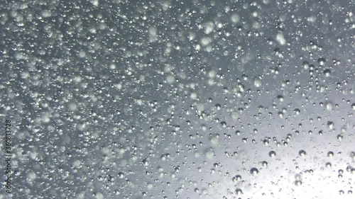 air bubbles float in liquid with colour light.