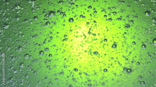 air bubbles float in liquid with colour light.
