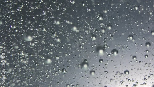 air bubbles float in liquid with colour light.