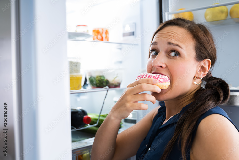 Hungry Young Woman Eating Donuts Hungry Young Woman Eating Donuts