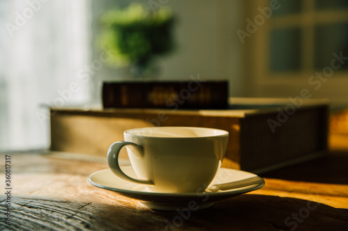 A white coffee mug on a wooden office desk