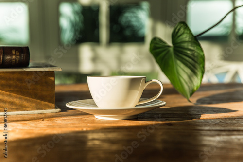 A white coffee mug on a wooden office desk