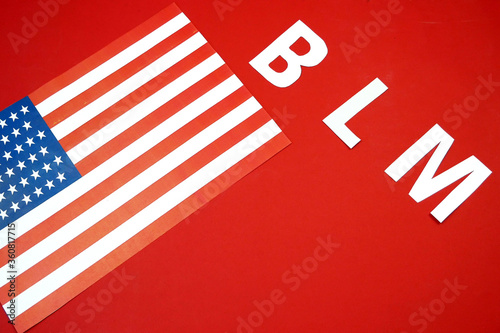 black lives matter concept, letters BLM, american flag with copy spacel on red background photo