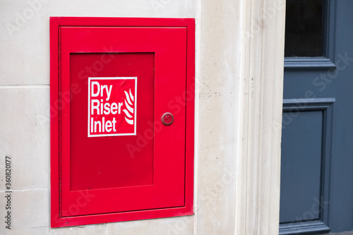 Dry riser red inlet box and sign at wall photo
