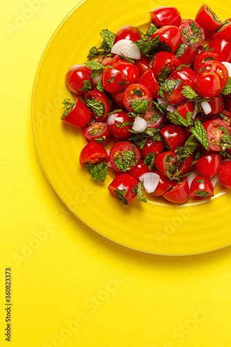 Homemade cherry tomato salad with fresh onions  mint  olive oil and salt